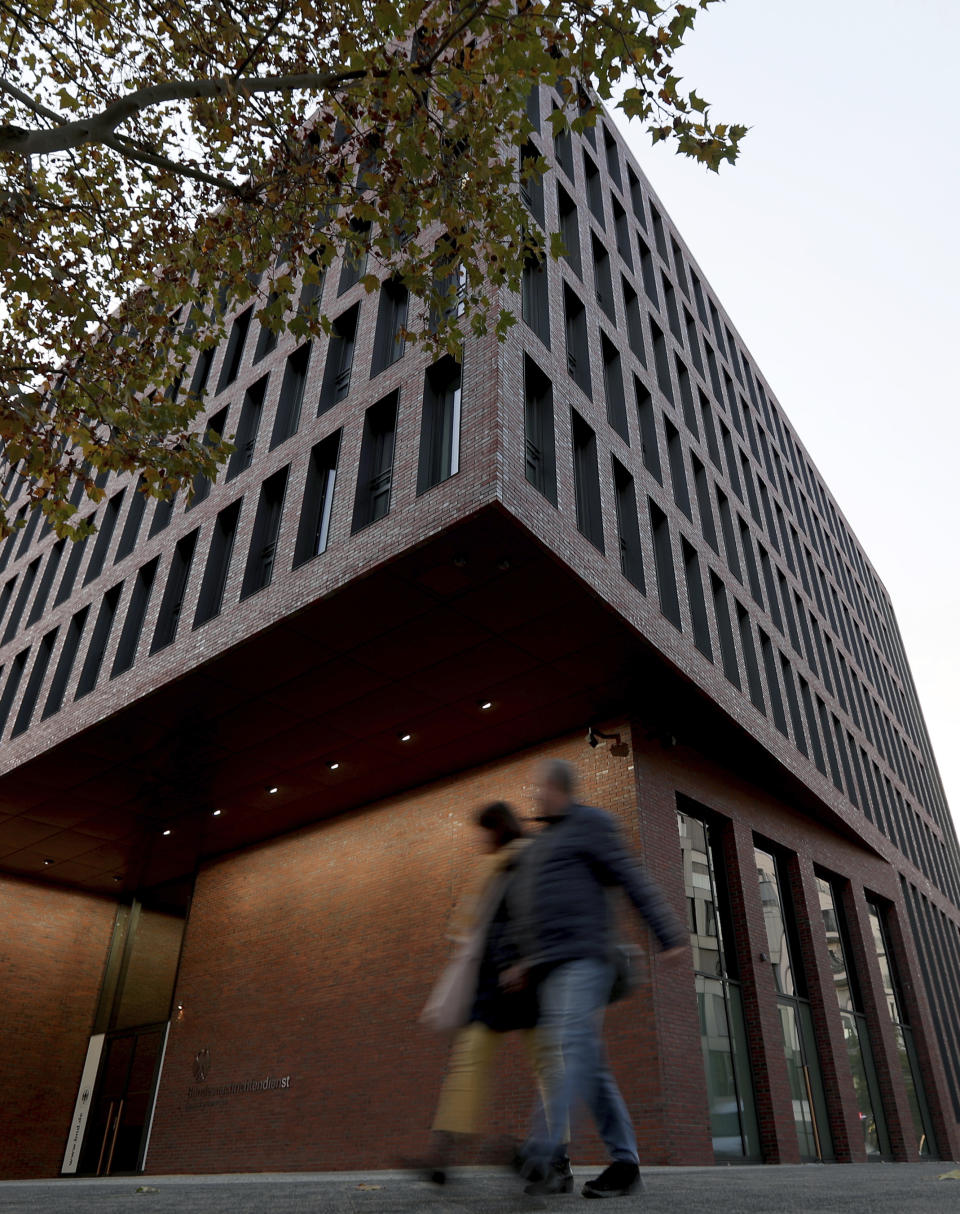 People walk past the center for advanced education (ZNAF) at the Federal Intelligence Service (BND) in Berlin, Germany, Tuesday, Nov. 12, 2019. Germany's intelligence agencies are inaugurating a joint spy school in the heart of Berlin, a city that was dubbed the 'capital of spies' during the Cold War and remains a hotspot of espionage.(AP Photo/Michael Sohn)