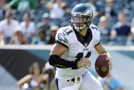 FILE - In this Aug. 16, 2015, file photo, Philadelphia Eagles' Tim Tebow looks to pass during the second half of a preseason NFL football game against the Indianapolis Colts in Philadelphia. Tebow and coach Urban Meyer are together again, this time in the NFL and with Tebow playing a new position. The former Florida star and 2007 Heisman Trophy-winning quarterback signed a one-year contract with the Jacksonville Jaguars on Thursday, May 20, 2021, and will attempt to revive his pro career as a tight end. (AP Photo/Matt Rourke, File)