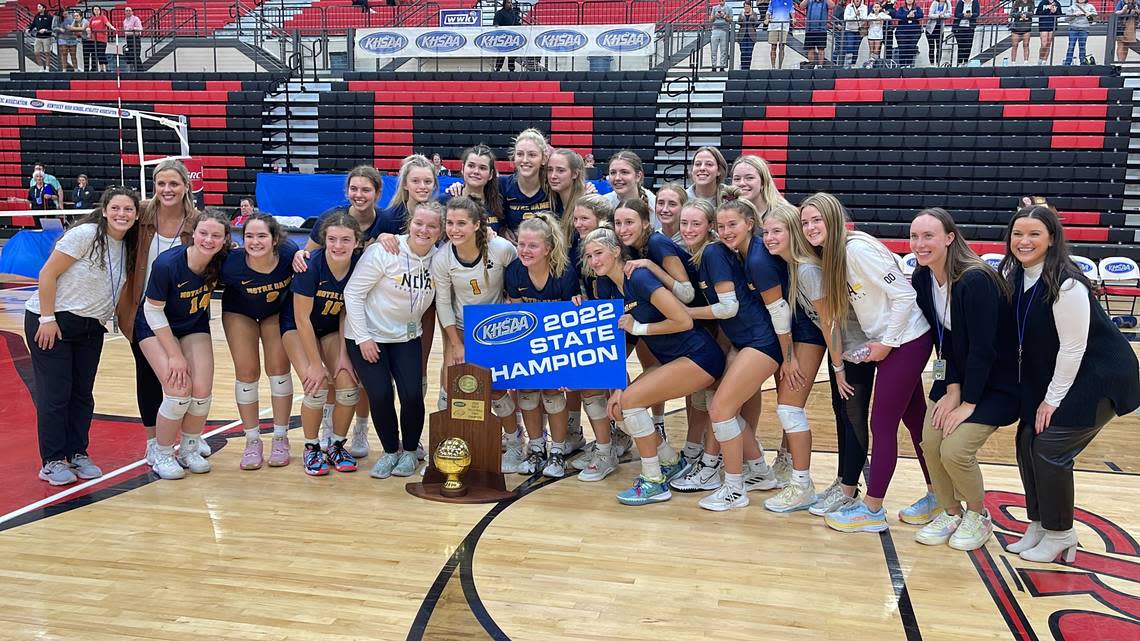 Notre Dame Academy players and coaches posed with the KHSAA State Volleyball Tournament championship trophy after their straight-sets win over Paul Laurence Dunbar at George Rogers Clark High School in Winchester on Friday night.