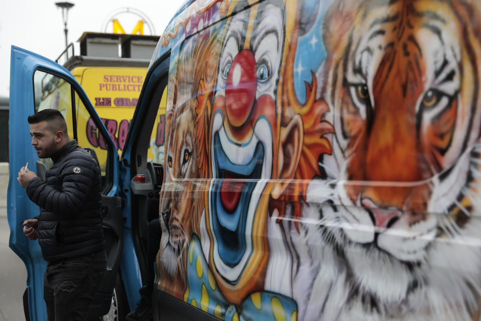 A circus worker leaves his van during a protest Tuesday, Jan.26, 2021. French lawmakers start debating Tuesday a bill that would ban using wild animals in traveling circuses and keeping dolphins and whales in captivity in marine parks, amid other measures to better protect animal welfare. Circus workers stage a protest outside the National Assembly to denounce what they consider "a mistake." (AP Photo/Lewis Joly)