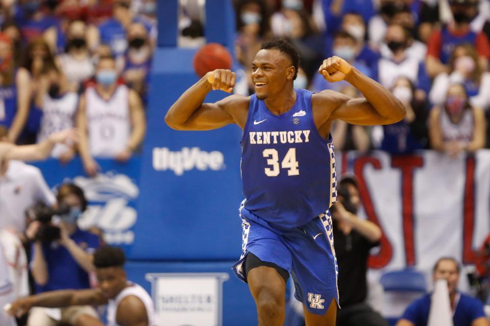 Kentucky forward Oscar Tshiebwe (34) flexes after scoring over Kansas during the second half of Saturday's game inside Allen Fieldhouse.