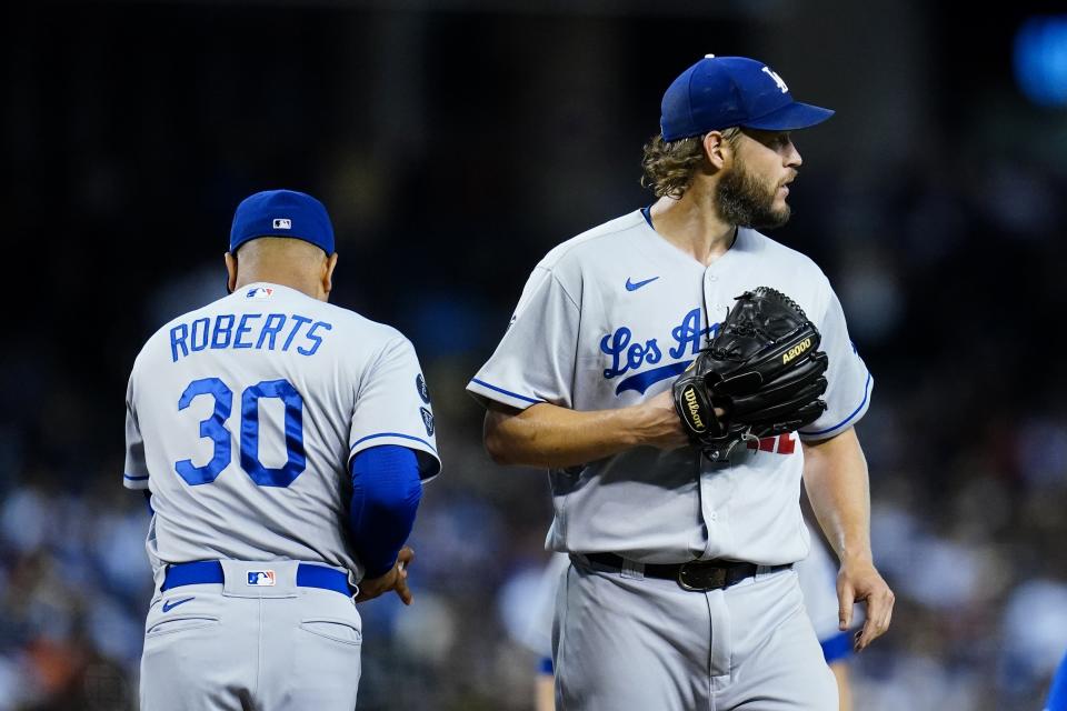 Los Angeles Dodgers starting pitcher Clayton Kershaw, right, is taken out by Dodgers manager Dave Roberts (30) during the fifth inning of a baseball game against the Arizona Diamondbacks Saturday, Sept. 25, 2021, in Phoenix. (AP Photo/Ross D. Franklin)