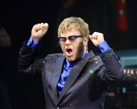 Musician Elton John performs songs off his new album "The Diving Board" with USC Thornton School of Music students in Los Angeles, California on September 16, 2013. REUTERS/Kevork Djansezian/Files