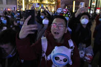 Supporters of the 2022 Beijing Winter Olympics cheer as they mark the start of the 100 days countdown to the opening of the Winter Olympics in Beijing, China, Tuesday, Oct. 26, 2021. (AP Photo/Ng Han Guan)