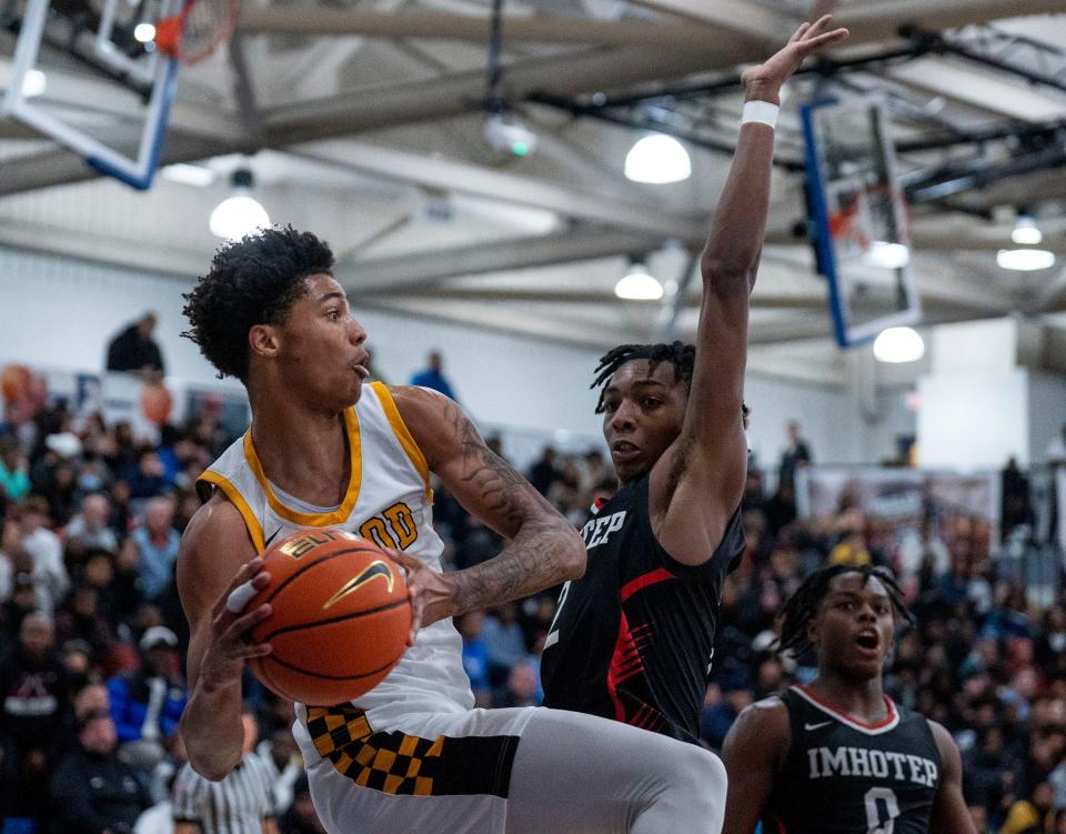 Archbishop Wood's Jalil Bethea (1) looks to pass the ball against Imhotep Charter's Carnell Henderson (2) in the Diane Mosco Shootout in Bensalem on Friday, Dec. 22, 2023.

Daniella Heminghaus | Bucks County Courier Times