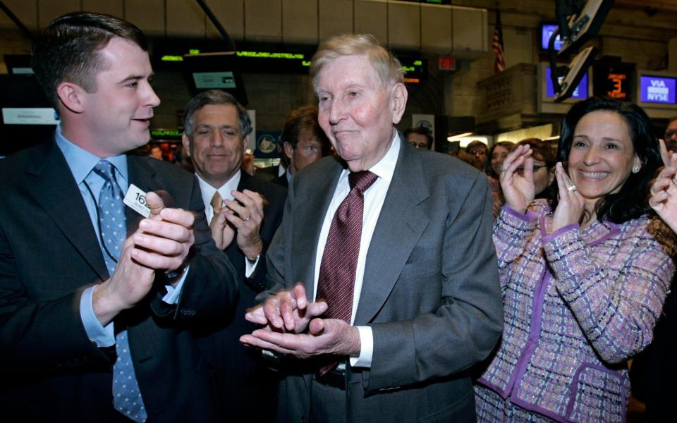 Centre of it all: CBS Chairman Sumner Redstone, third from left, is applauded as the new CBS Corp in 2006 - AP