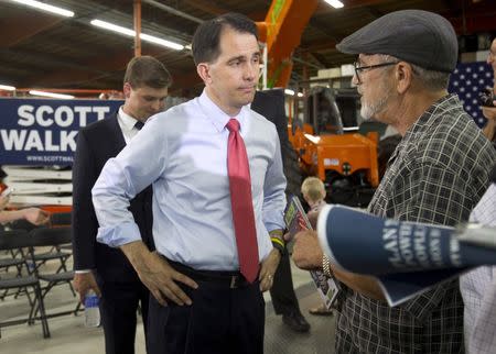 Republican presidential candidate Wisconsin Gov. Scott Walker (C) listens to Steve Small following a town hall meeting at the Xtreme Manufacturing warehouse in Las Vegas, Nevada September 14, 2015. REUTERS/Las VegasSun/Steve Marcus