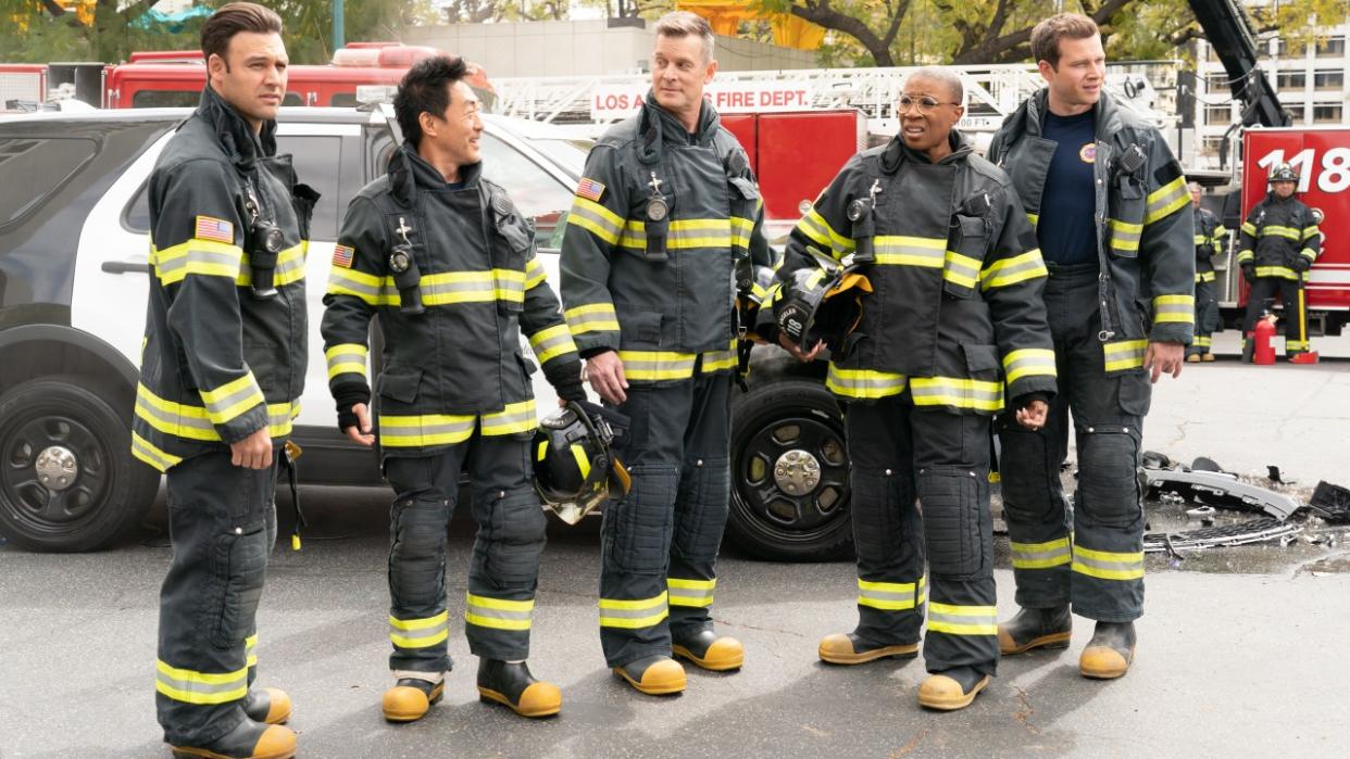  From left to right: RYAN GUZMAN, KENNETH CHOI, PETER KRAUSE, AISHA HINDS, OLIVER STARK all standing in their fire gear. 