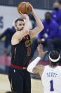 Cleveland Cavaliers' Kevin Love (0) shoots over Philadelphia 76ers' Mike Scott (1) in the first half of an NBA basketball game, Thursday, April 1, 2021, in Cleveland. (AP Photo/Ron Schwane)