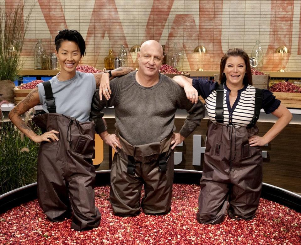 "Top Chef: Wisconsin" host Kristen Kish (from left) and perennial judges Tom Colicchio and Gail Simmons waded in a makeshift cranberry bog before announcing Episode 9's Quickfire Challenge theme.