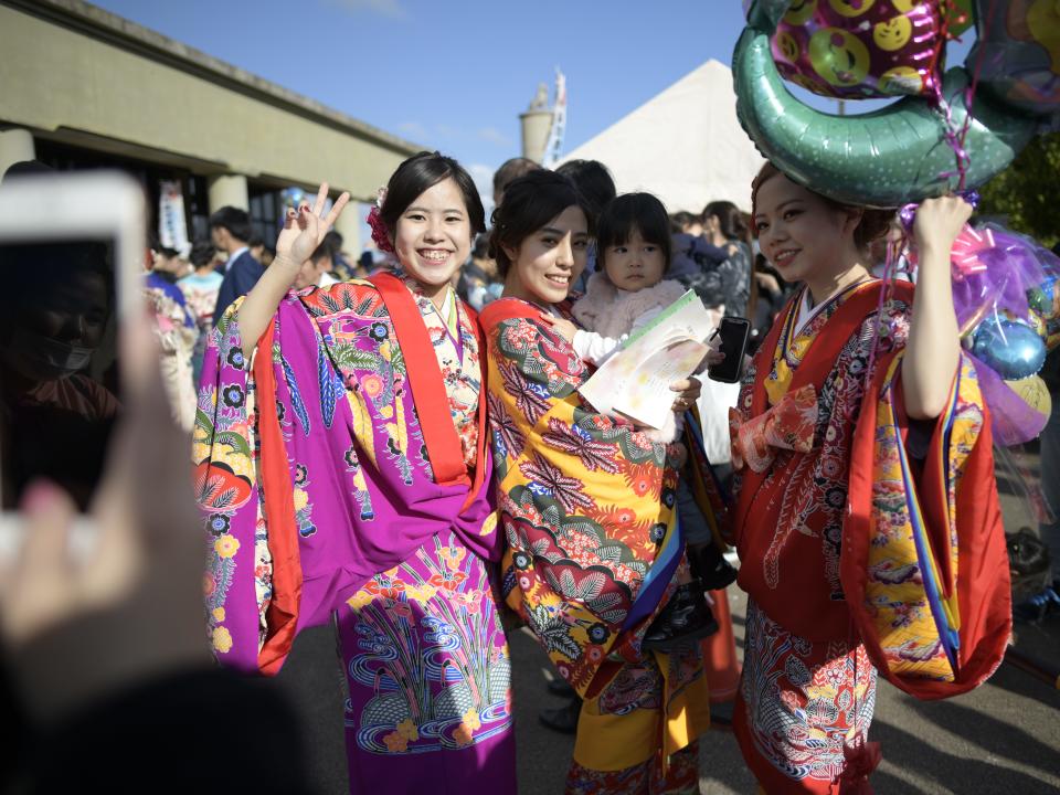 Okinawan women in a kimono poses for a photograph after attending a ceremony on Coming of Age Day on January 13, 2019 in Civic Hall of Okinawa, Okinawa City, Japan.