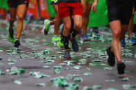 <p>Runners step on used water cups discarded on the street during the 2017 New York City Marathon, Nov. 5, 2017. (Photo: Gordon Donovan/Yahoo News) </p>