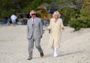 <p>Upon arriving in Grenada, Prince Charles and the Duchess of Cornwall took a stroll along a beach in St. George. Camilla wore a cream colored caftan with white embroidery, white wide leg pants, and sunglasses. </p>