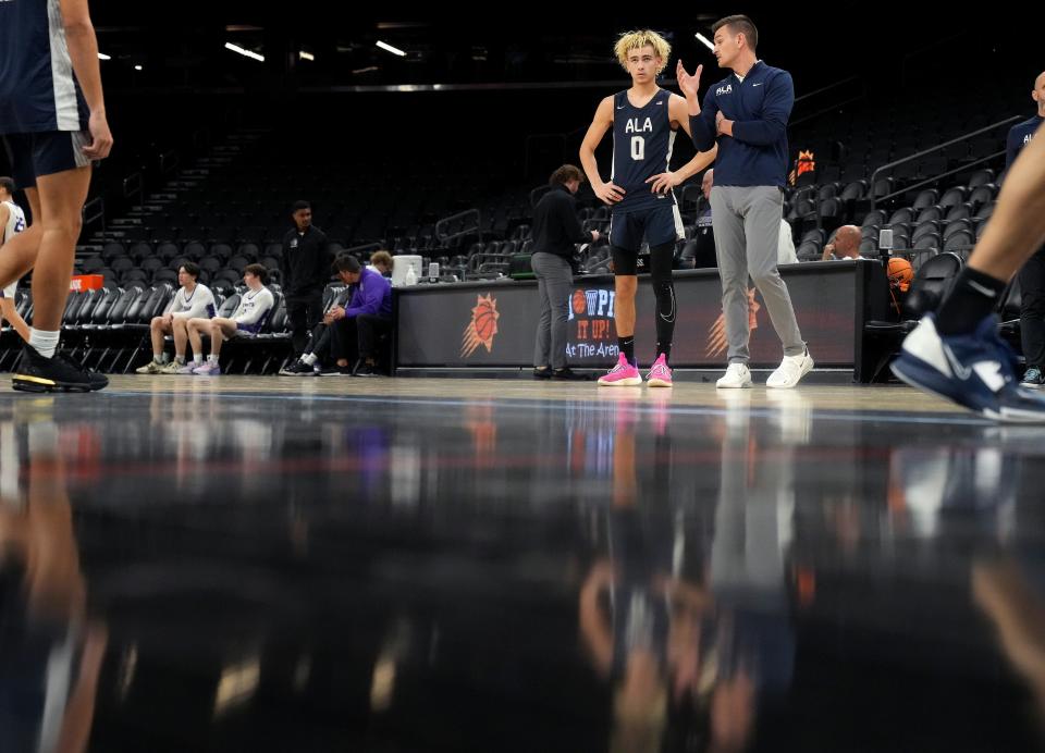 American Leadership Academy Gilbert North Eagles sophomore point guard Dylan Novak (0) speaks his his head coach, and father, Dave Novak as they take on the Arizona College Prep Knights at the Footprint Center on Saturday, Jan. 7, 2023. 