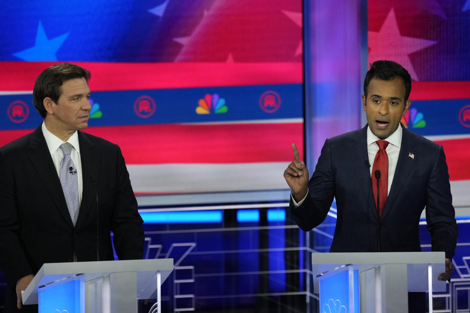 Republican presidential candidate businessman Vivek Ramaswamy speaks as Florida Gov. Ron DeSantis listens during a Republican presidential primary debate hosted by NBC News, Wednesday, Nov. 8, 2023, at the Adrienne Arsht Center for the Performing Arts of Miami-Dade County in Miami. (AP Photo/Rebecca Blackwell)