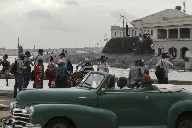 people watch the Russia's Kazan nuclear-powered submarine arrive in the port of Havana, Cuba, Wednesday, June 12, 2024