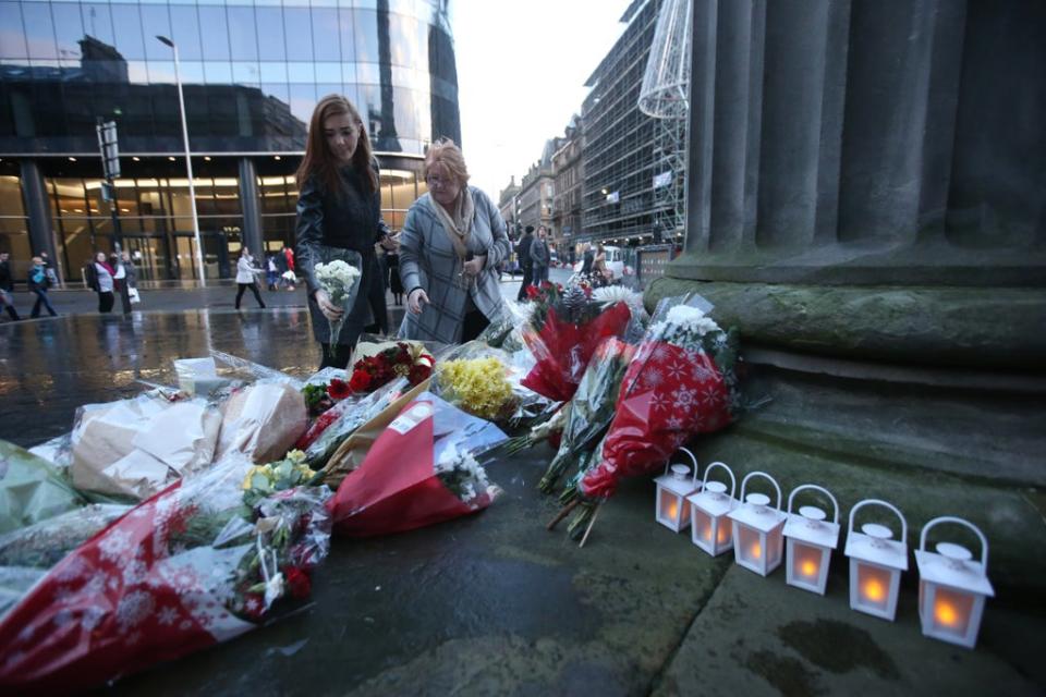 Flowers and tributes left in Royal Exchange Square dedicated to those who were killed in the Glasgow bin lorry crash (Andrew Milligan/PA) (PA Archive)
