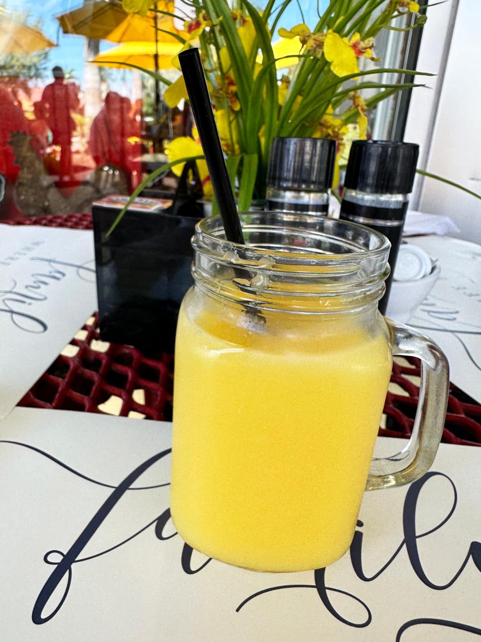 A mug of orange juice from Red Rooster, Marco Island.