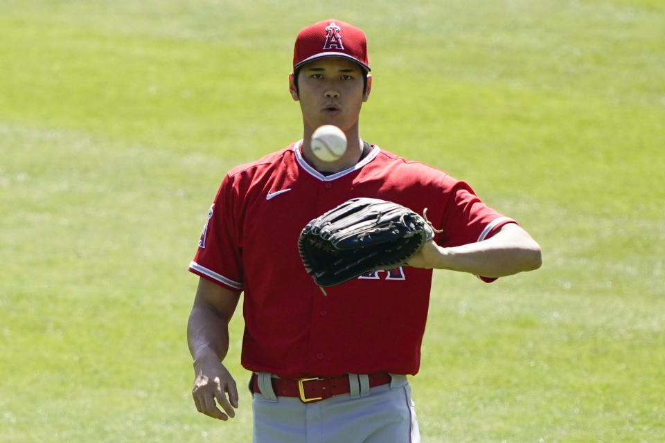 Los Angeles Angels designated hitter Shohei Ohtani (17) catches a ball during a baseball practice at Angels Stadium on Friday, July 3, 2020, in Anaheim, Calif. (AP Photo/Ashley Landis)