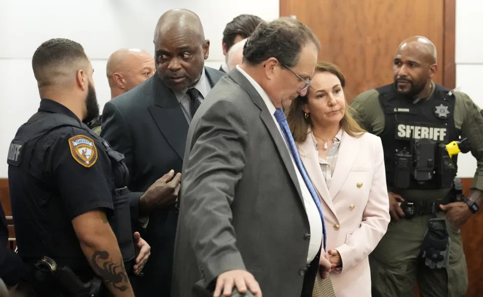 Former Houston police officer Gerald Goines is taken into custody and his defense attorneys Reagan Wynn, front center, and Nicole DeBorde Hochglaube, second right, react to the guilty verdict in his murder trial in the 482nd District Court at the Harris County Criminal courthouse Wednesday, Sept. 25, 2024, in Houston. A jury found Goines guilty of two counts of murder in the January 2019 deaths of Dennis Tuttle and his wife Rhogena Nicholas. (Melissa Phillip/Houston Chronicle via AP, Pool)