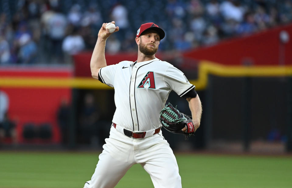 PHOENIX, ARIZONA - APRIL 15: Merrill Kelly #42 of the Arizona Diamondbacks delivers a pitch against the Chicago Cubs at Chase Field on April 15, 2024 in Phoenix, Arizona. All players are wearing the number 42 in honor of Jackie Robinson Day. (Photo by Norm Hall/Getty Images)