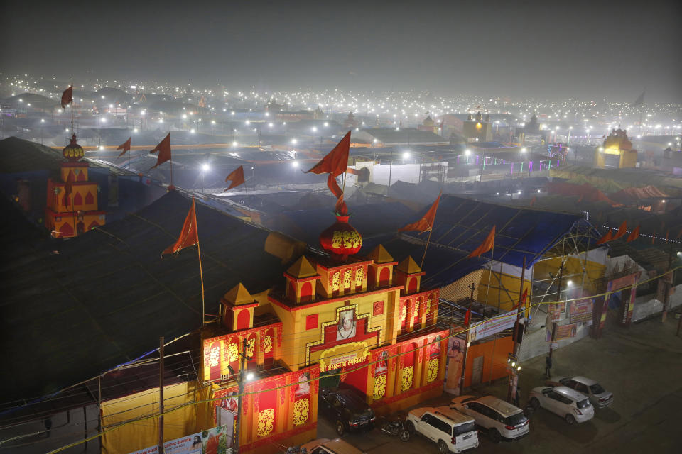 In this Monday, Jan. 14, 2019, photo, a thick layer of dust is seen over the tent city set up for the spiritual-cleansing Kumbh Festival in Prayagraj, India. The skies over the confluence of sacred rivers in north India where millions of Hindu priests and pilgrims have come to wash away their sins for the Kumbh Mela, or pitcher festival, that begins this week are thick with toxic dust, a sign that Indian government officials are struggling to grapple with India's worsening air pollution. (AP Photo/Rajesh Kumar Singh)