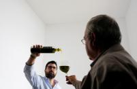 Men test olive oil at an olive oil cooperative in Porcuna, southern Spain