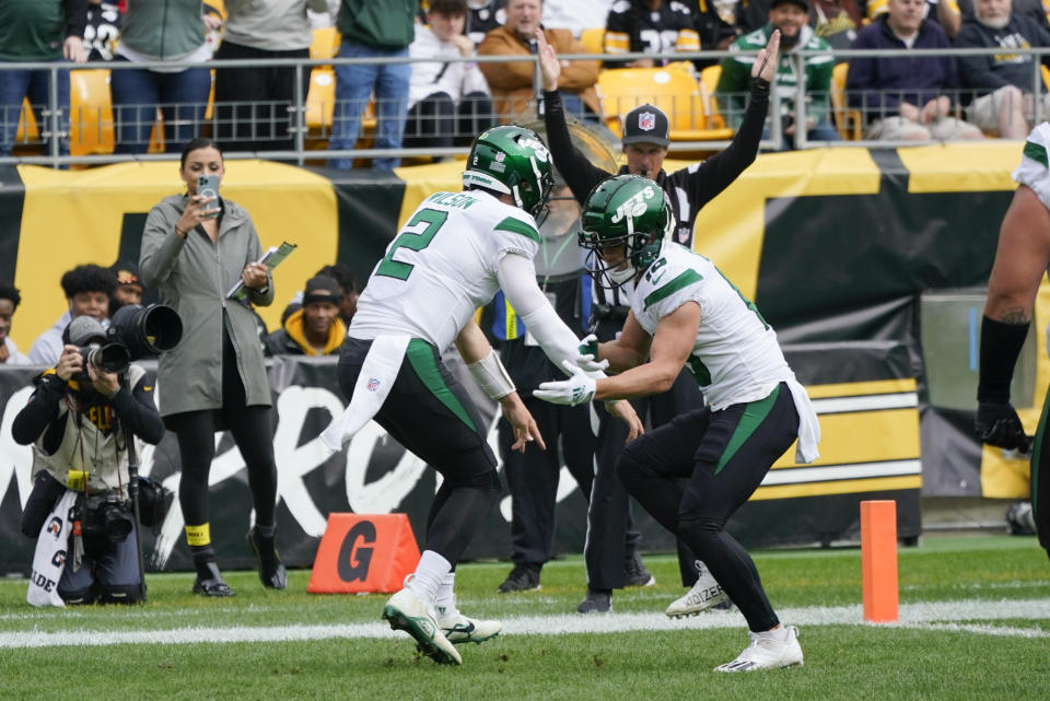 New York Jets quarterback Zach Wilson (2) celebrates with wide receiver Braxton Berrios (10) after Wilson made a touchdown against the Pittsburgh Steelers during the first half of an NFL football game, Sunday, Oct. 2, 2022, in Pittsburgh. (AP Photo/Gene J. Puskar)