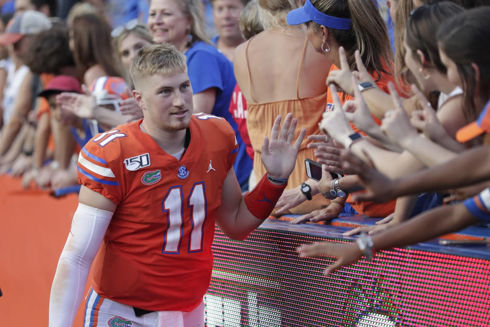 Florida quarterback Kyle Trask (11) high fives fans after defeating Towson in an NCAA college football game, Saturday, Sept. 28, 2019, in Gainesville, Fla. (AP Photo/John Raoux)