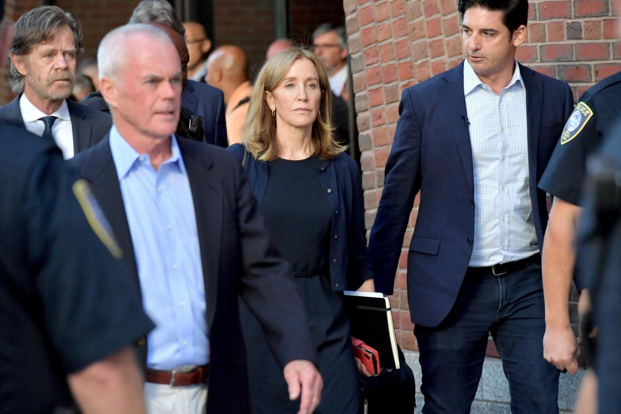 Felicity Huffman and husband William Macy exit John Moakley U.S. Courthouse where Huffman received a 14 day sentence for her role in the college admissions scandal on September 13, 2019 in Boston, Massachusetts.