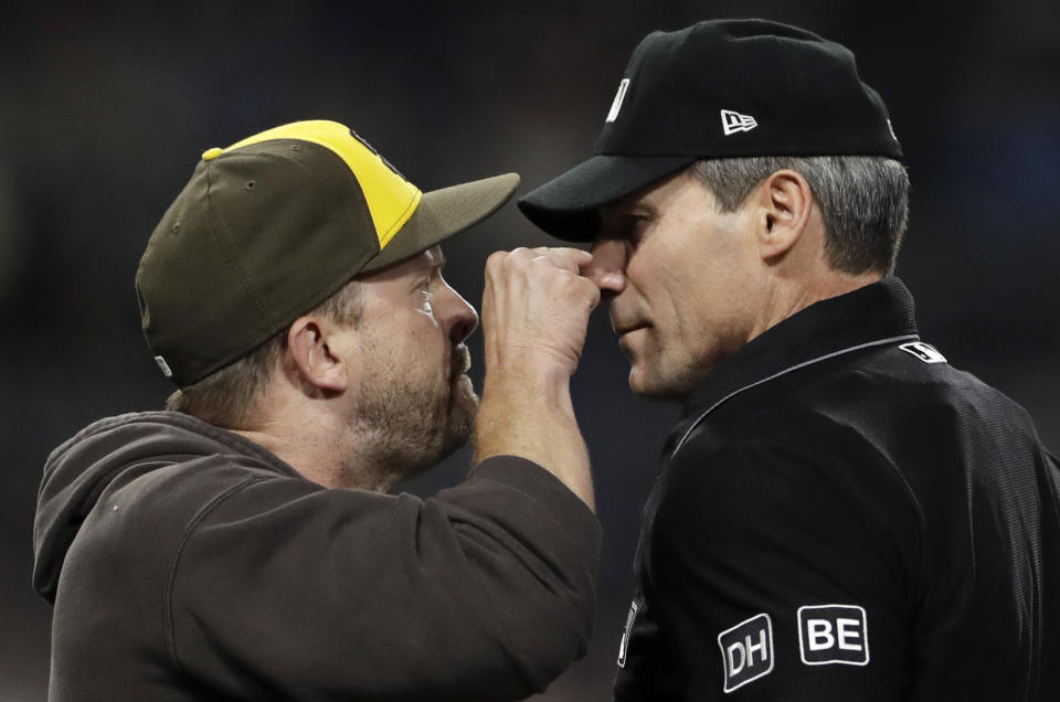 FILE - San Diego Padres manager Andy Green, left, argues with home plate umpire Angel Hernandez before being ejected between the third and fourth innings of the team's baseball game against the Pittsburgh Pirates, June 29, 2018, in San Diego. Longtime umpire Hernández, who unsuccessfully sued Major League Baseball for racial discrimination, is retiring immediately, announced Monday, May 27, 2024. (AP Photo/Gregory Bull, File)