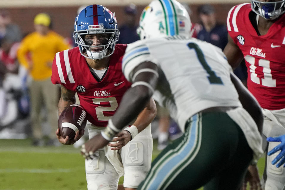 Mississippi quarterback Matt Corral (2) tries to run past Tulane linebacker Nick Anderson (1) during the first half of an NCAA college football game, Saturday, Sept. 18, 2021, in Oxford, Miss. (AP Photo/Rogelio V. Solis)