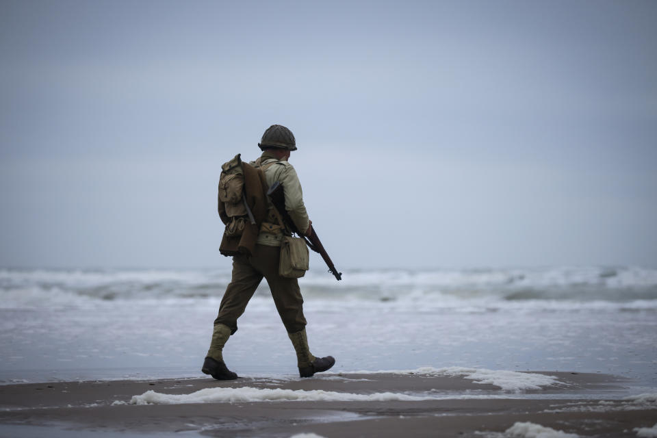 A World War II reenactor walks on Omaha Beach in Saint-Laurent-sur-Mer, Normandy, France, Tuesday, June 6, 2023. The D-Day invasion that helped change the course of World War II was unprecedented in scale and audacity. Nearly 160,000 Allied troops landed on the shores of Normandy at dawn on June 6, 1944. (AP Photo/Thomas Padilla)