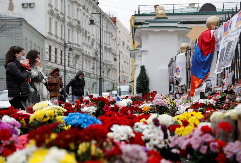 People visit a makeshift memorial outside the Armenian embassy for the victims of a military conflict over the breakaway region of Nagorno-Karabakh in Moscow