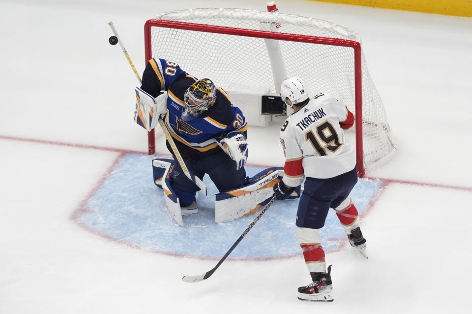 St. Louis Blues goaltender Joel Hofer (30) deflects a puck as Florida Panthers' Matthew Tkachuk (19) watches during the second period of an NHL hockey game Tuesday, Jan. 9, 2024, in St. Louis. (AP Photo/Jeff Roberson)