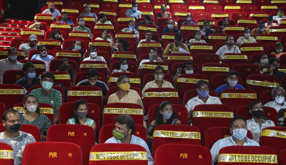 People wait to get inoculated against COVID-19 at a cinema hall in Mumbai, India, Tuesday, Aug. 17, 2021. (AP Photo/Rafiq Maqbool)