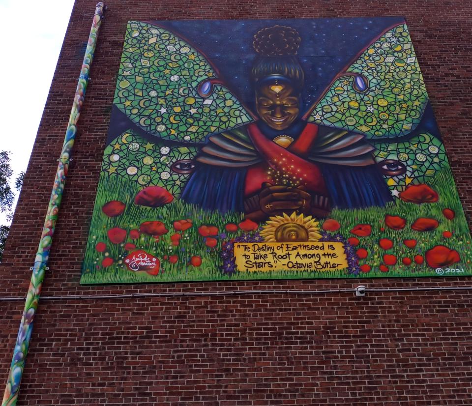 Moringa the Medicine Woman is just one mural in the Afro-Pollinator series by local collective Juniper Creative Arts, a Black-Dominican artist family. Moringa is located on the back of the O.N.E Community Center at 20 Allen Street.