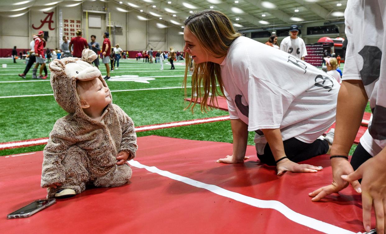 Oct 31, 2022; Tuscaloosa, AL, USA; The University of Alabama athletics department sponsored a night of Halloween fun with student athletes Monday night in the Hank Crisp Indoor Practice Facility. Gymnast Lilly Hudson gets a cute smile from Russell Owen Wilson who goes by Row. 