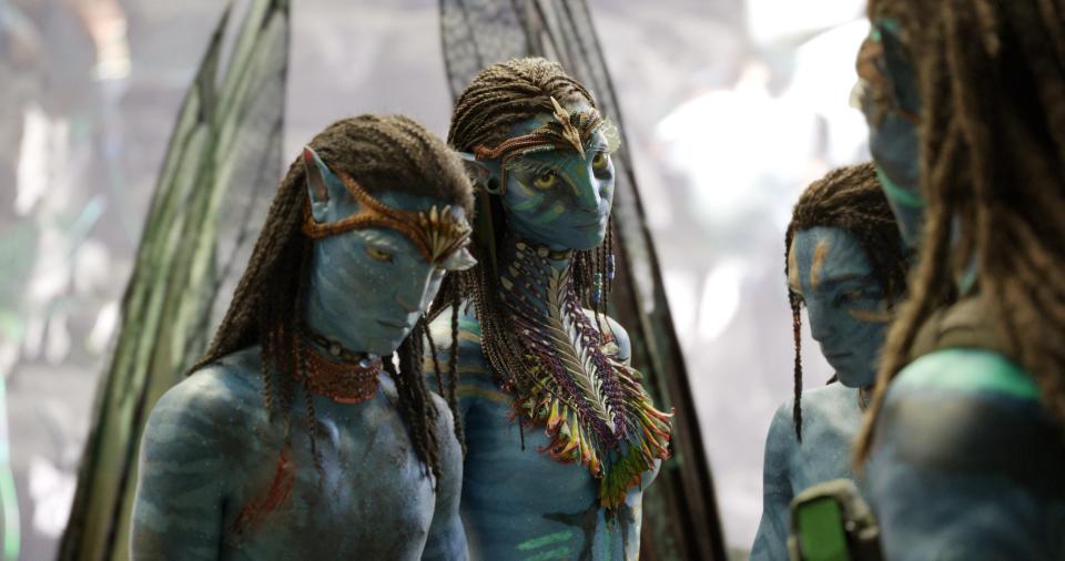 Na'vi warrior Neytiri (Zoe Saldana, center) returns in the new sequel "Avatar: The Way of Water" with her sons, Neteyam (Jamie Flatters) and Lo’ak (Britain Dalton).