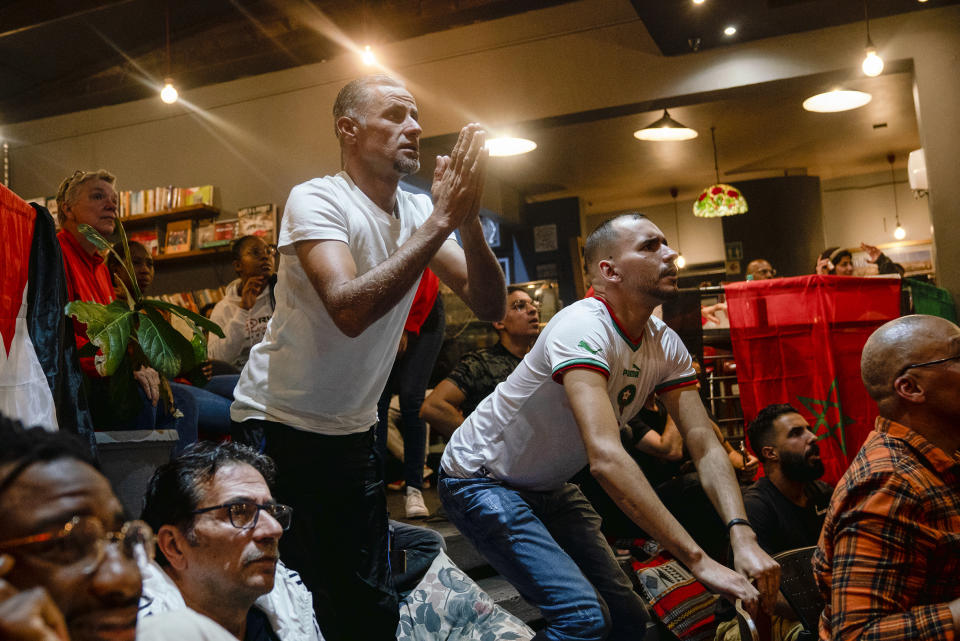 Moroccans and fans react as they watch in Johannesburg, South Africa, the World Cup semifinal soccer match between Morocco and France played in Qatar Wednesday, Dec. 14, 2022. France won 2-0 and moved to the final. (AP Photo/Shiraaz Mohamed)