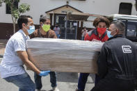 Relatives carry the remains of a loved one in a cardboard coffin for burial, as they leave a church in Guayaquil, Ecuador, Monday, April 6, 2020. Guayaquil, a normally bustling city that has become a hot spot in Latin America as the coronavirus pandemic spreads, also has untold numbers dying of unrelated diseases that can’t be treated because hospitals are overwhelmed. (AP Photo/Luis Perez)