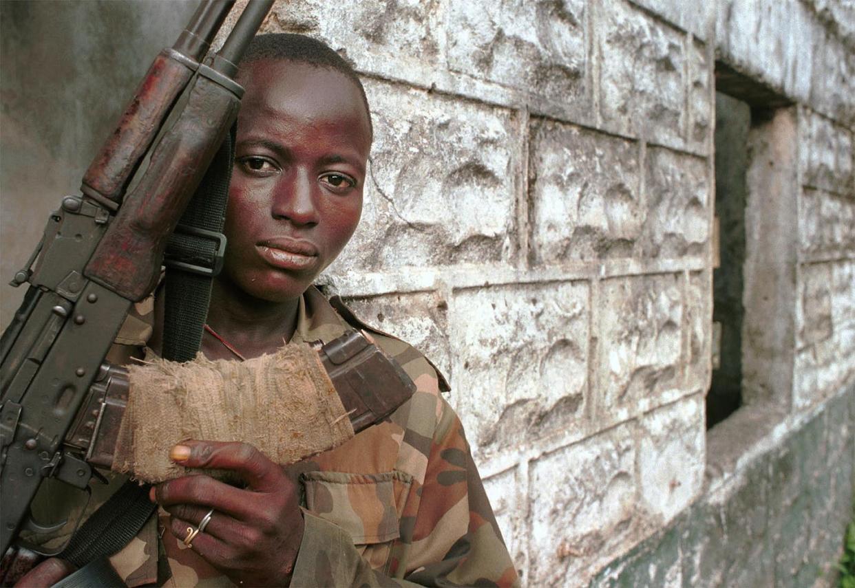 Henry, a teenaged rebel solider, before he is disarmed in 2001. Photo by Chris Hondros/Getty Images