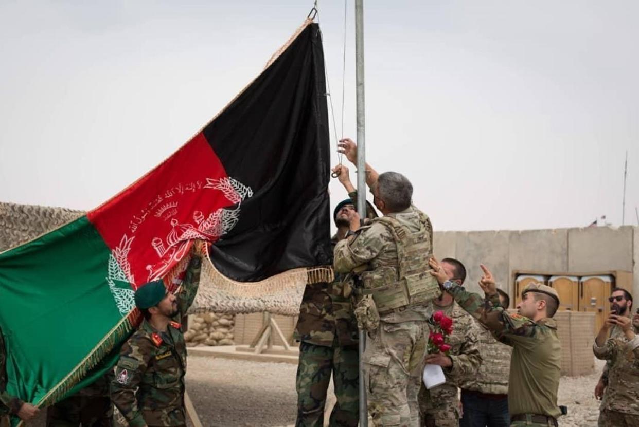 <span class="caption">In May, Afghan troops raised their national flag as the U.S. pulled out. Now, their flag is down too.</span> <span class="attribution"><a class="link " href="https://newsroom.ap.org/detail/AfghanistanTimeLine/427de00c8eb7482da3df9fa0015bcd47/photo" rel="nofollow noopener" target="_blank" data-ylk="slk:Afghan Ministry of Defense Press Office via AP;elm:context_link;itc:0;sec:content-canvas">Afghan Ministry of Defense Press Office via AP</a></span>