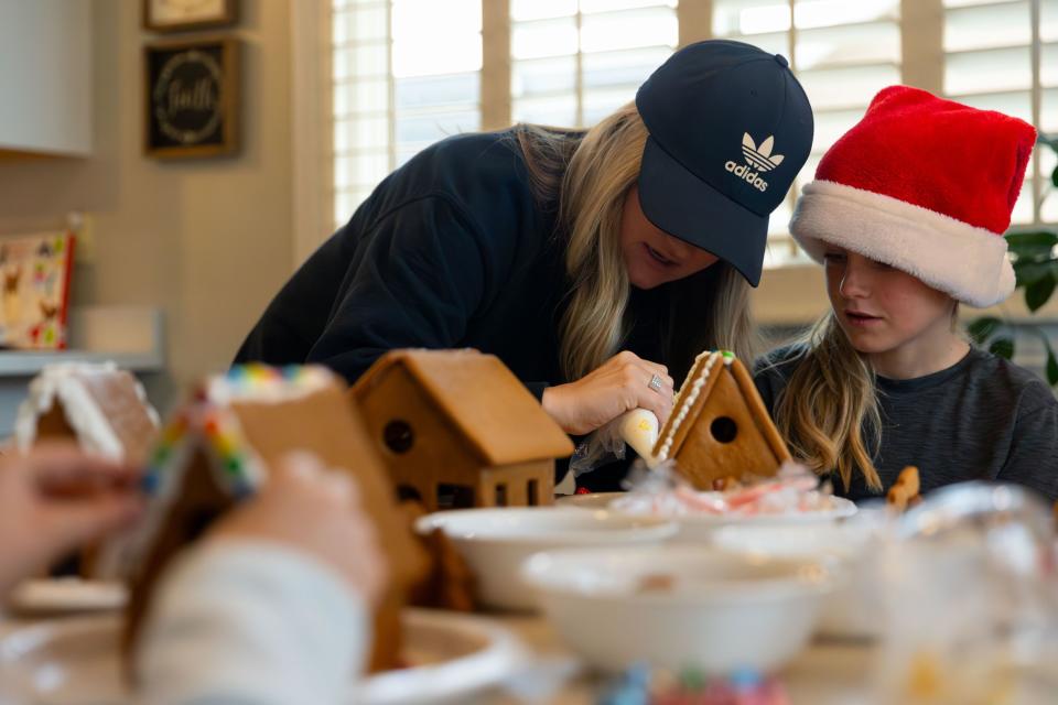 Kali Priday, left, helps her son Jaxon, 10, ice his gingerbread house at their home in Saratoga Springs on Sunday, Dec. 3, 2023. | Megan Nielsen, Deseret News