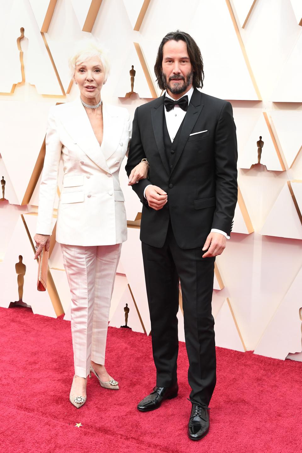 Keanu Reeves with Patricia Taylor (both in Dolce & Gabbana, Keanu in Cartier cufflinks)