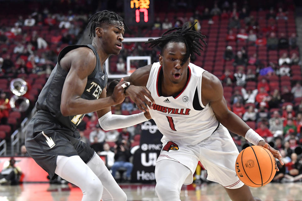 Louisville guard Mike James (1) drives on Georgia Tech guard Miles Kelly (13) during the second half of an NCAA college basketball game in Louisville, Ky., Wednesday, Feb. 1, 2023. Louisvile won 68-58. (AP Photo/Timothy D. Easley)