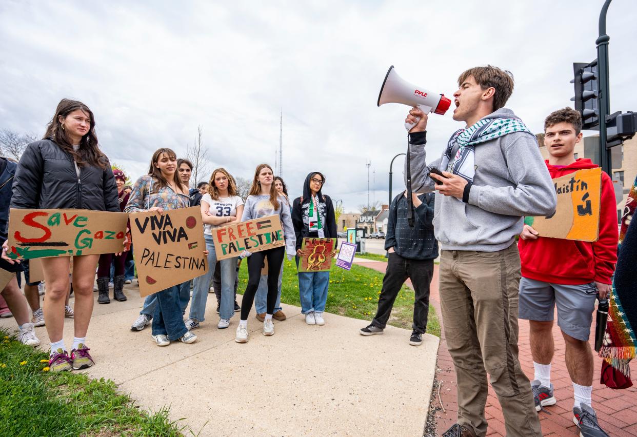 Shorewood High School senior Sam Diliberti leads students with chants as they walk out of classes heading toward the University of Wisconsin-Milwaukee encampment on Thursday.