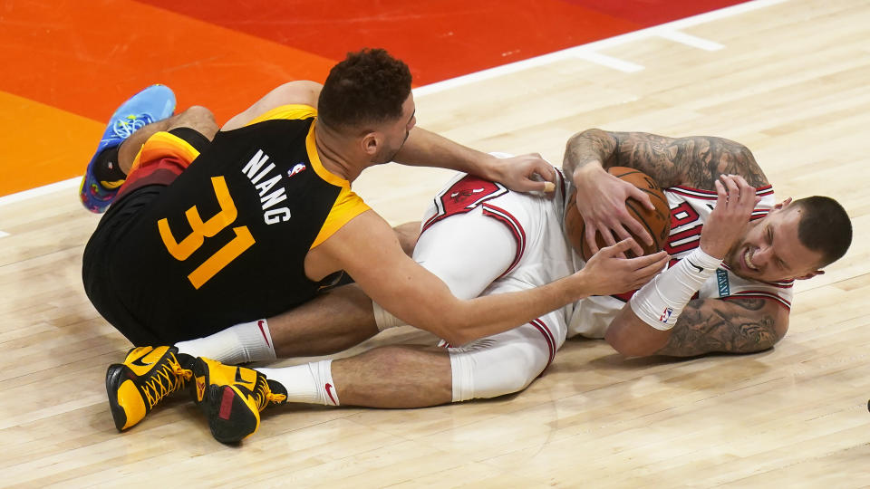 Chicago Bulls center Daniel Theis, right, and Utah Jazz forward Georges Niang (31) battle for the ball in the second half during an NBA basketball game Friday, April 2, 2021, in Salt Lake City. (AP Photo/Rick Bowmer)