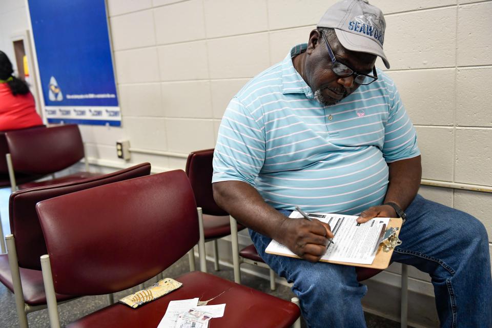 Henry Thomas fills out paperwork to get his drivers license at the Saluda Dam Road Department of Motor Vehicles office in Berea on Thursday, May 25, 2025. Henry hasn't driven by himself in 25 years.