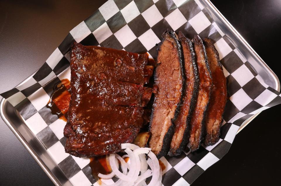 A half pound of brisket and a 1/3 rack of ribs served up hot and fresh at The Normal BBQ in Lima, Thursday, July 6, 2023.  The ribs are St. Louis-cut pork spareribs with dry rub, served with lingonberry sauce.